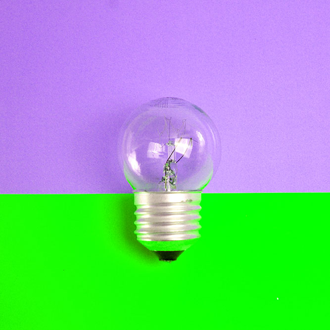 Light bulb against a blue and yellow color-block background