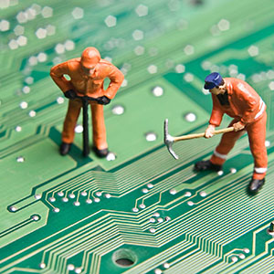 Photograph of toy people on a computer board