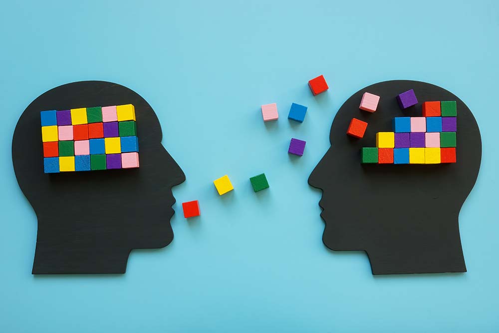 Profile of a human head with colorful blocks filling in to create a rectangle shape